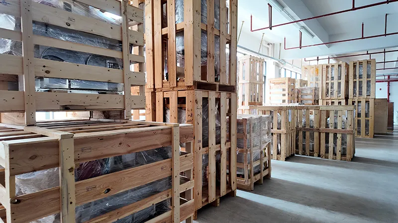 Export-ready food processing equipment crates stored inside a factory warehouse