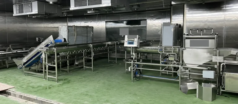Stainless steel salad processing equipment and inclined conveyors during site installation