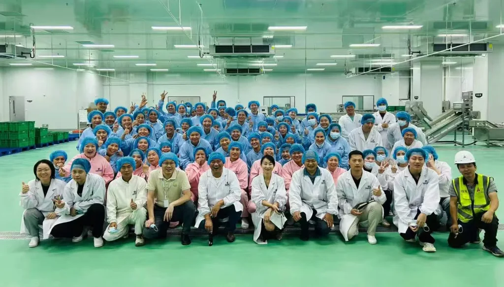 Food processing operators and engineering staff inside a clean production facility