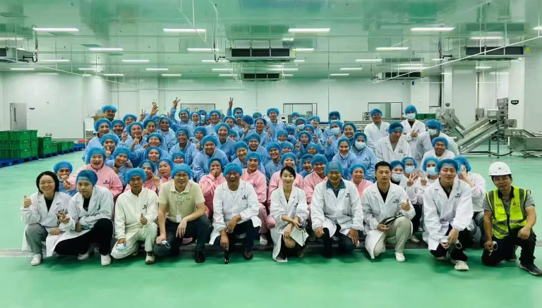 Food processing operators and engineering staff inside a clean production facility