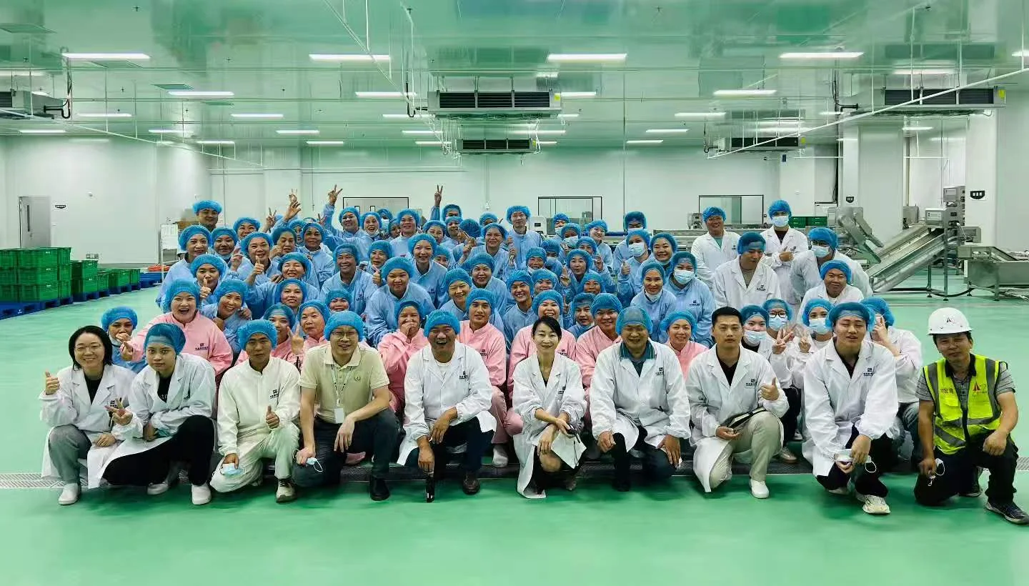 Food processing operators and engineering staff gathered inside a clean production facility