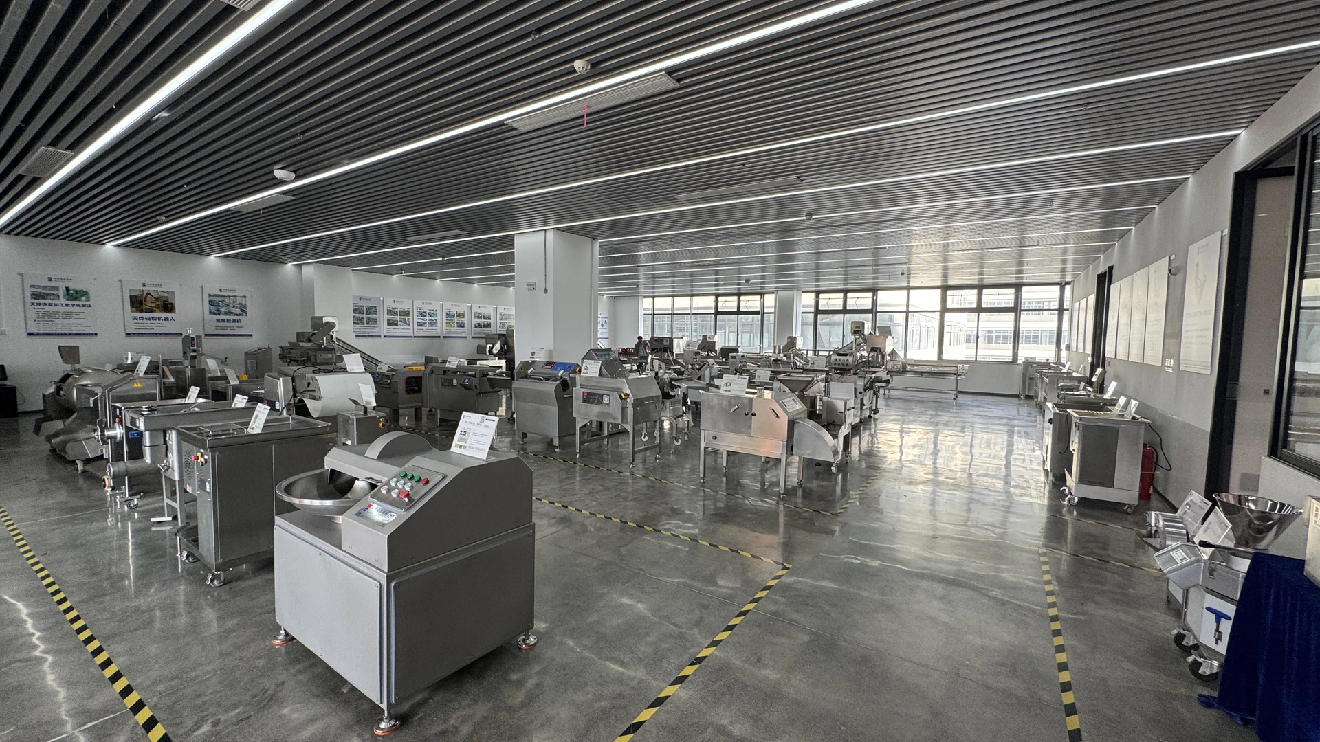 Wide view of the TEEMYEAH showroom with industrial food processing machinery