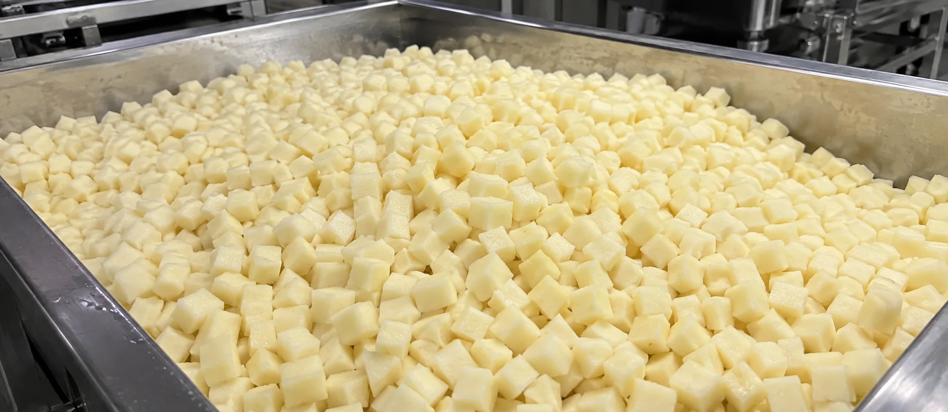 Prepared diced potatoes collected in a stainless-steel tray for batch allocation and dispatch