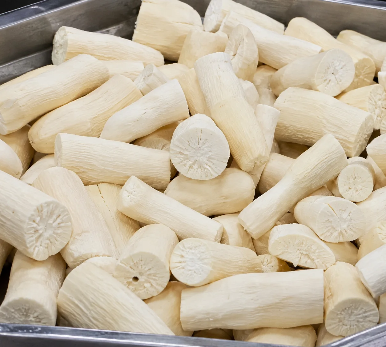 Peeled cassava sections after a yield-changing root vegetable process