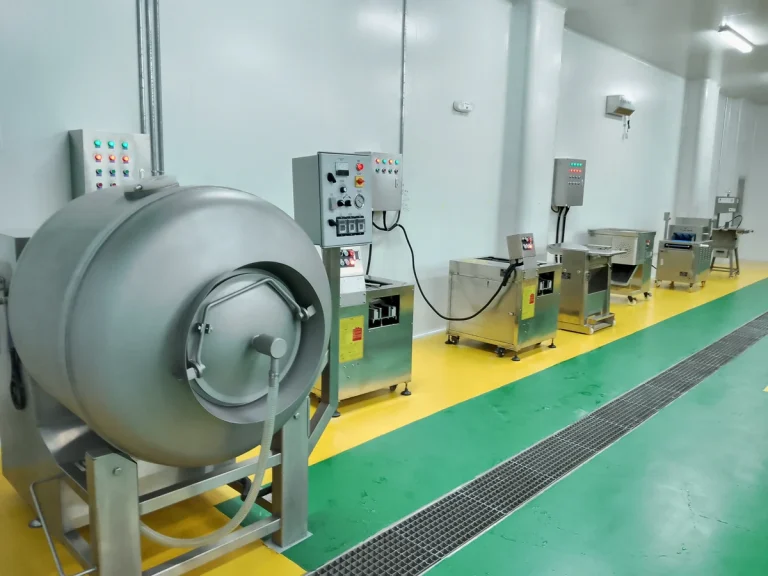 Stainless steel food preparation equipment and controls arranged along a production wall
