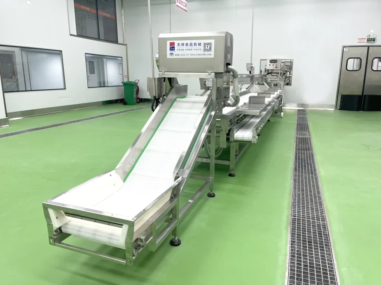 Stainless steel conveying and inspection equipment in a produce preparation facility